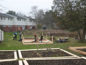 Volunteers building garden plots at the community garden work day